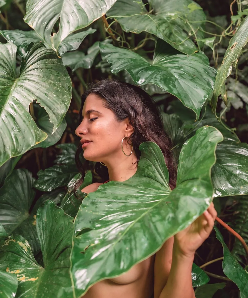 Bare photography, a woman among the leaves in the green