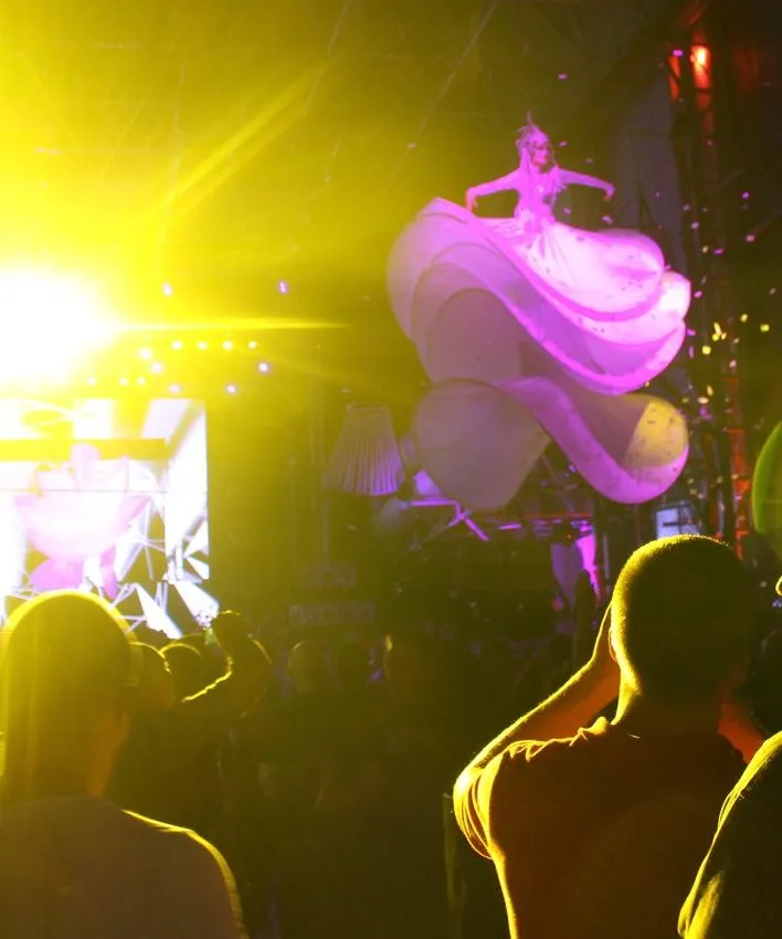 Nightlife photography, an aerial dancer in silk over the crowd
